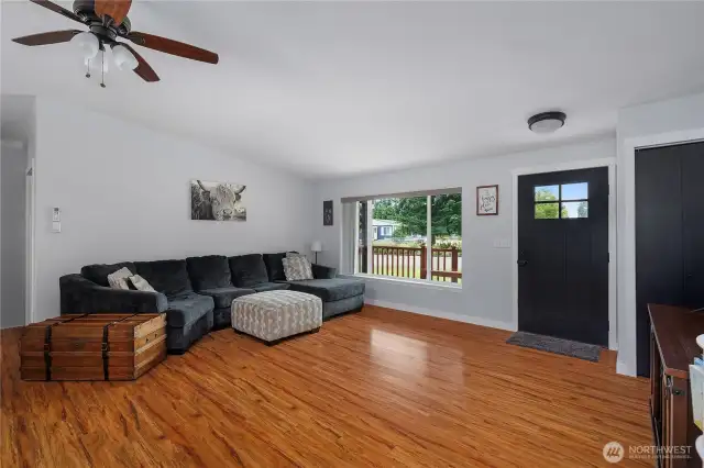 Spacious and bright living room with laminate flooring. Lots of natural light.