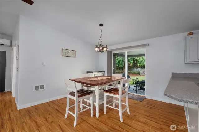 Sliding glass door opens to covered back patio for additional outdoor living space.