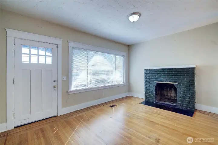 Enter into the living room complete with brick fireplace and real hardwoods with inlay.