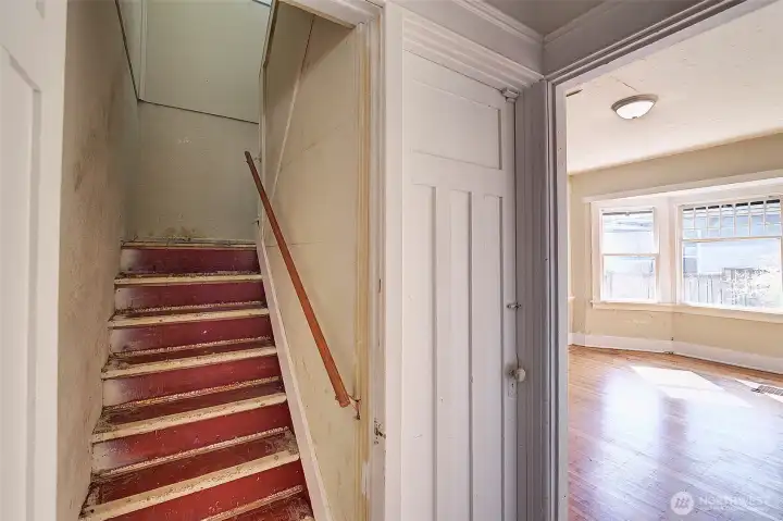 Staircase to the 2nd floor. Just to the right is the door down to the garage.