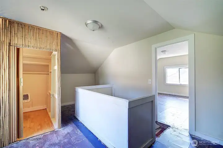 Upstairs loft area. See entrance to the bedroom on the right and half bath on the left.