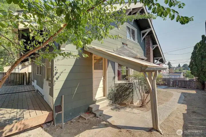 Side yard. Door goes into the kitchen.
