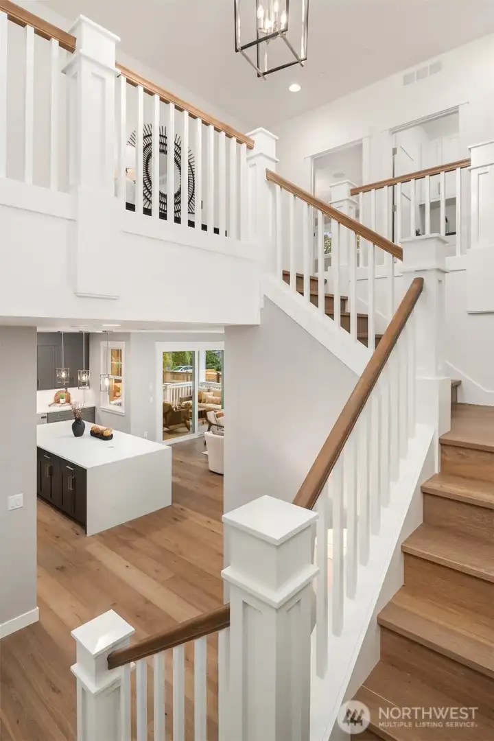 Stunning traditional staircase with handcrafted newel posts.