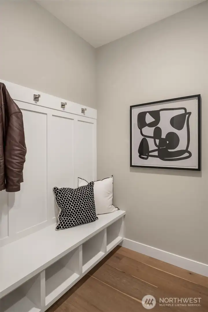 Mudroom alcove off Entry from Garage,  with built-in bench w/  coat hooks & cubies