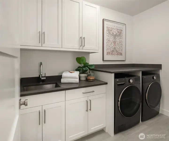 Wondeful Laundry room features LG Washer/Dryer, a large utility sink, abundant cabinets and folding counters.