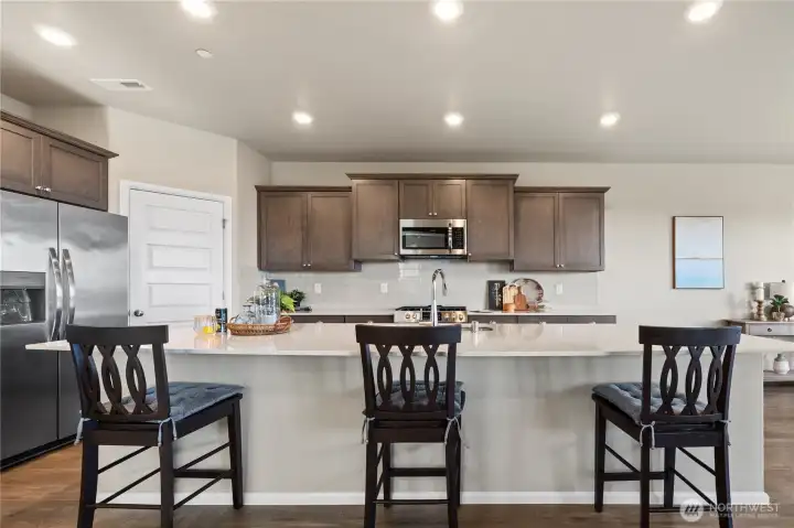 Well-appointed kitchen with island seating, modern finishes, and an open-concept layout