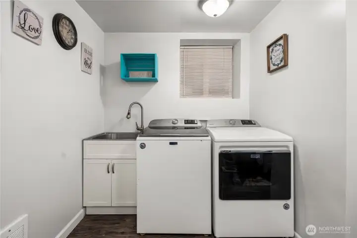 Laundry room area is spacious and clean.