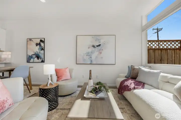 This sun-drenched living room offers a perfect blend of modern elegance and comfort, featuring large windows that flood the space with natural light. It's a sophisticated space designed for both relaxation and stylish entertaining in the heart of North Beacon Hill.comfortable year-round with a high-efficiency ductless mini-split system (A/C + Heat) and a tankless hot water heater.