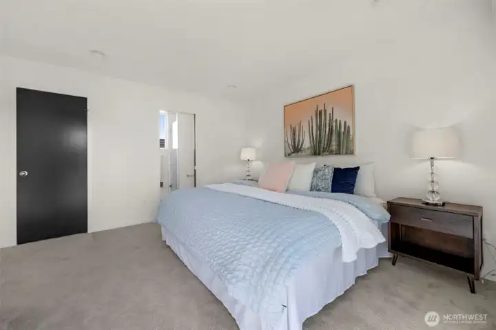The primary suite is completed by an oversized walk-in closet, providing abundant storage for your wardrobe and essentials. This expansive space ensures everything stays organized while maintaining the home's clean, modern aesthetic.
