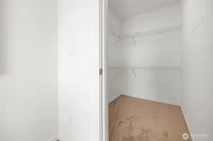 The primary suite is completed by an oversized walk-in closet, providing abundant storage for your wardrobe and essentials. This expansive space ensures everything stays organized while maintaining the home's clean, modern aesthetic.