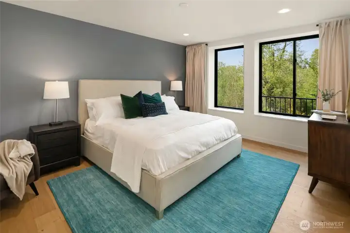 Primary bedroom lacated on the Bellevue Botanical Gardens for privacy year round.