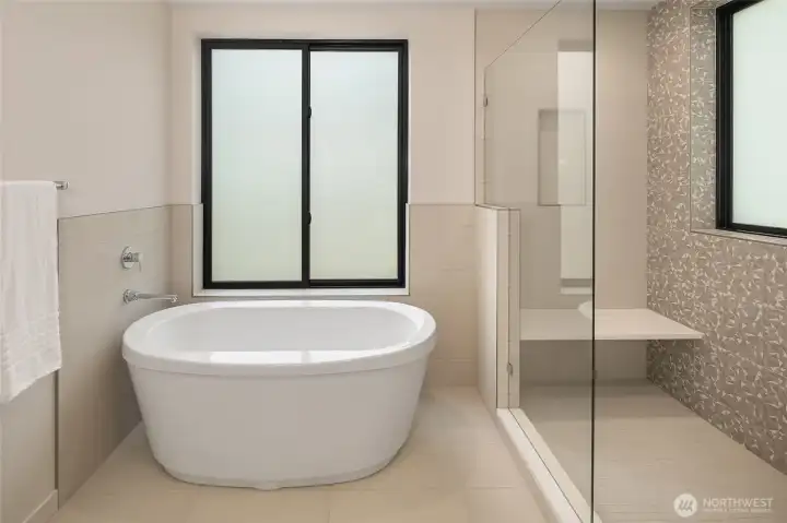 Free standing tub set in a bright tranquil space