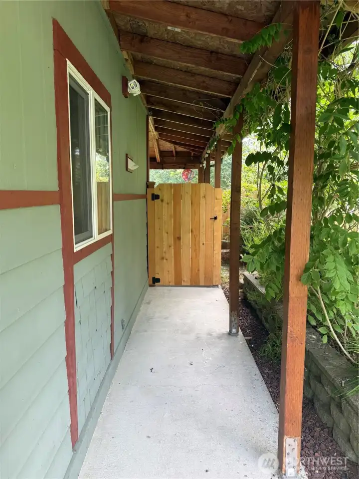 Gate on south side of house that leads to the backyard.