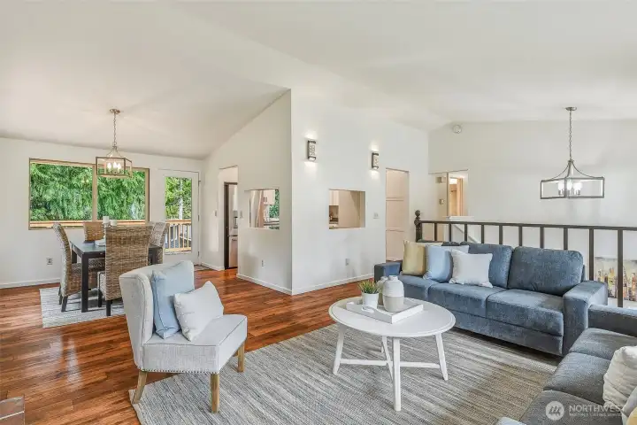 View to dining room. The kitchen is opened up to the living and dining rooms, facilitating conversation. Bedrooms are down the hall to your right