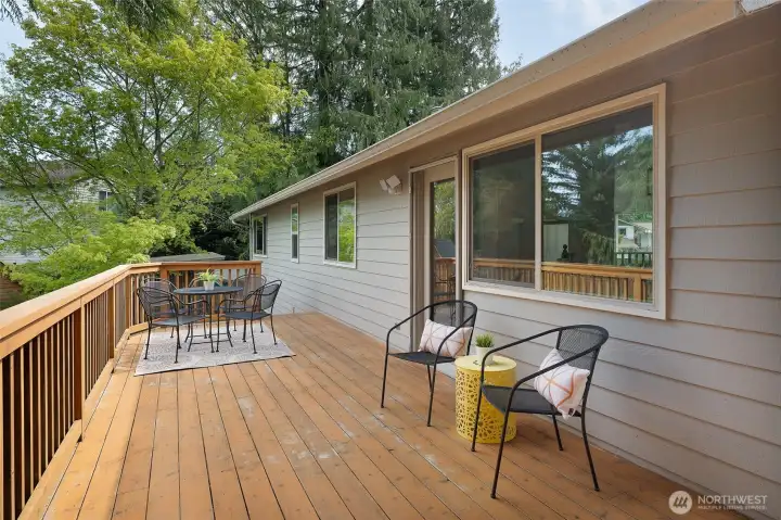 Large deck off the Dining Room has abundant space for entertaining. The deck wraps around the side of the house