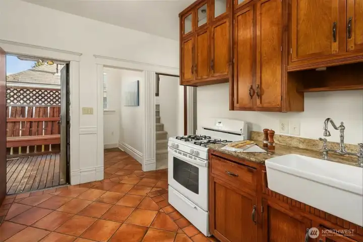 Kitchen with access to back patio, walk in pantry and stairs.
