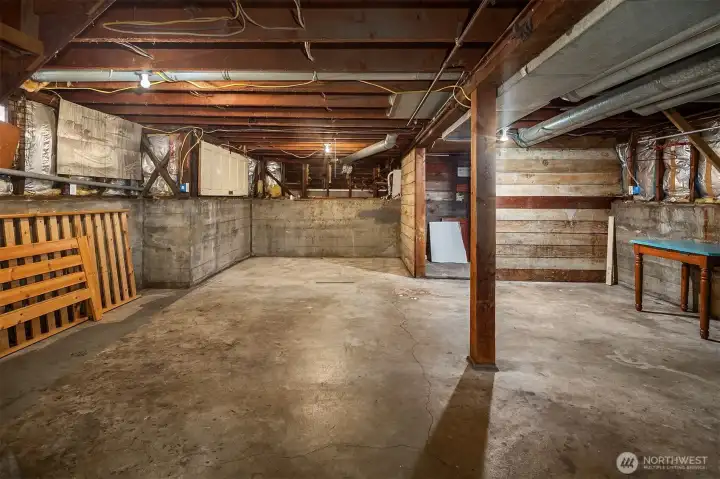 Unfinished basement offers storage and future finished potential.