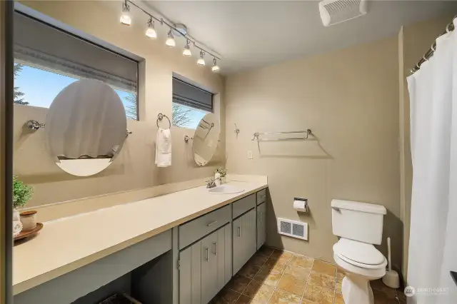 Full bath upstairs with large linen closet and under counter storage or vanity seating.