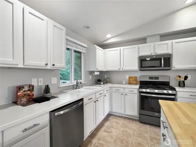 Kitchen features newer stainless steel appliances, and a gas range!