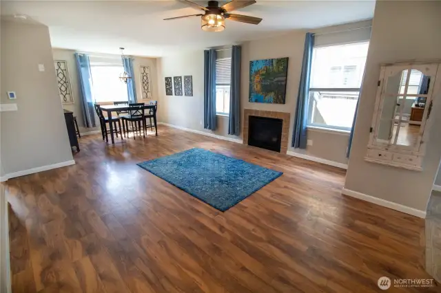 Natural light floods the room, and check out the cozy fireplace as well as those beautiful floors!