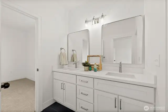 Stunning Jack-n-Jill full bath offers dual vanity, quartz counters and beautiful tile work.