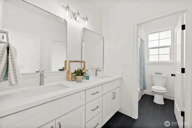 Private water closet with tub makes it easy and convenient to share this bathroom.