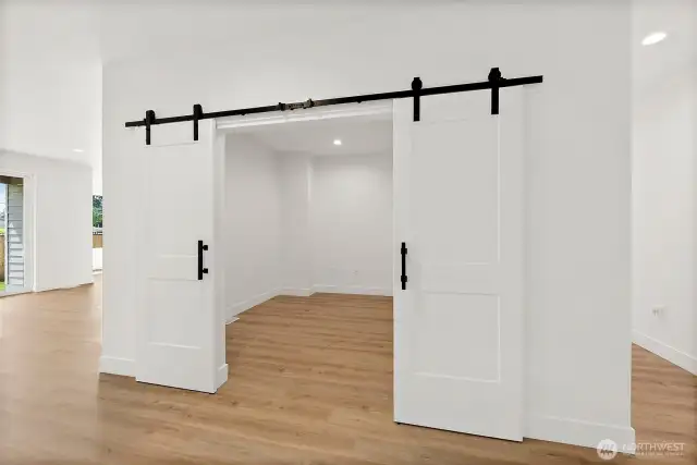 Centrally located find the bonus room with sleek and trending sliding doors. Utilize this space as an office, exercise room or another guest room.