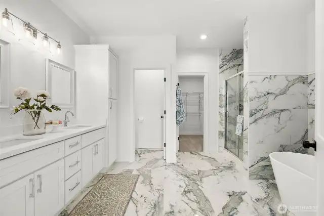 Gorgeous Private Primary Suite bathroom feels like you are at the Spa! Dual vanity, walk-in shower, freestanding soaking tub, water closet and walk-in closet. Stunning porcelain tile floors and walls compliment the cabinets.