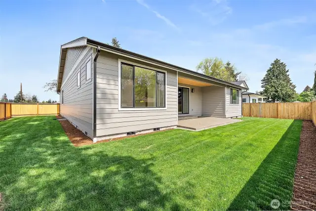 Wiggle your toes in the lush green grass in the backyard. 6 ft. fence optimizes privacy and separation.
