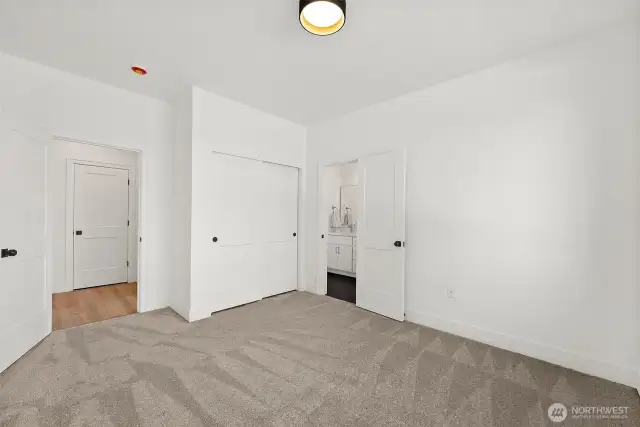 One of two guest bedrooms shown without furniture. Connecting Jack-n-Jill bathroom is genius!