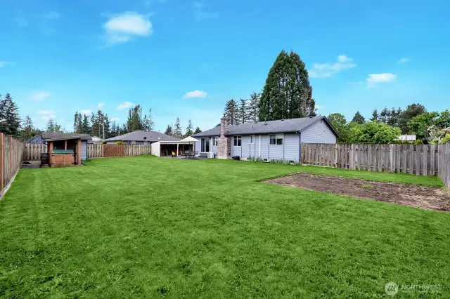 Another view of large fenced backyard