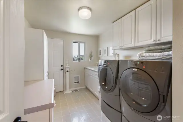 The large laundry has access to the back yard (hint-perfect for that hot tub you were thinking about). There is a large laundry sink and lots of storage.  The washer and dryer are included in the sale of this lovely home.