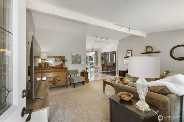 Step inside to an open living room.  To the left are three bedrooms and a hall bath.