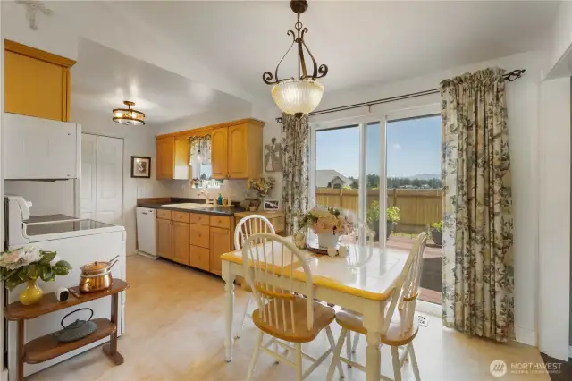 The cheerful kitchen and dining space are full of morning light to start your day off right.  To the right is a larger space should you want to have a larger dining space.  To the left is a walk in pantry for extra storage.