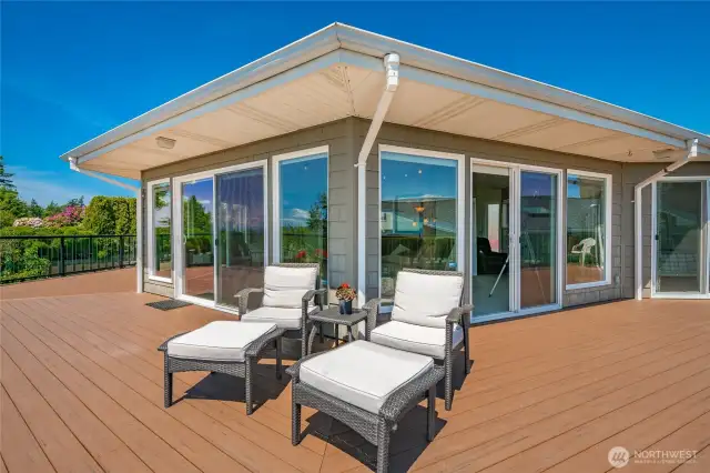Large wrap-around trex deck with glass railing