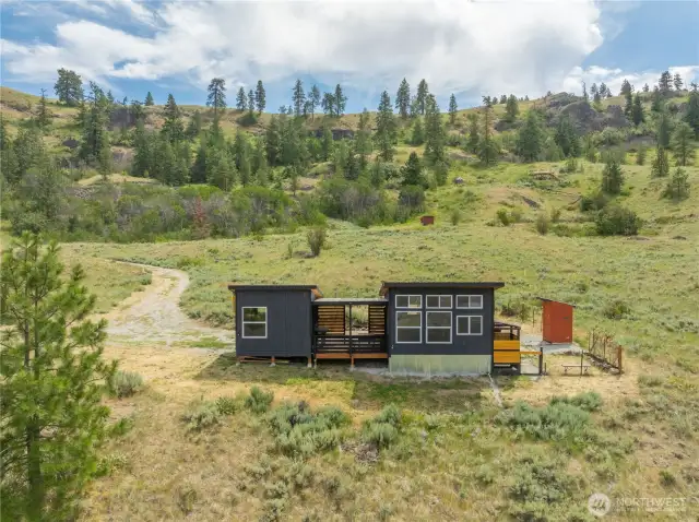 Sustainable and self-sufficient, the cabins are powered by a solar power station (included), while a rainwater collection system supplies water to the kitchen and outdoor shower. A thoughtfully designed self-composting outhouse completes this eco-conscious getaway. Electricity is just down the road for future connection if desired.