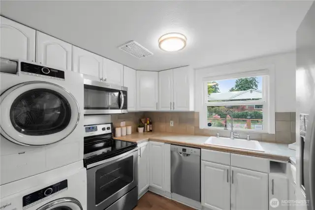 Kitchen with convenient washer and dryer.