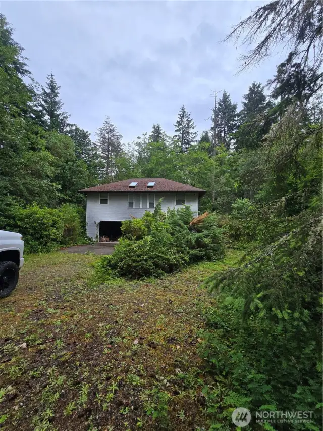 Front of house with large driveway and garage