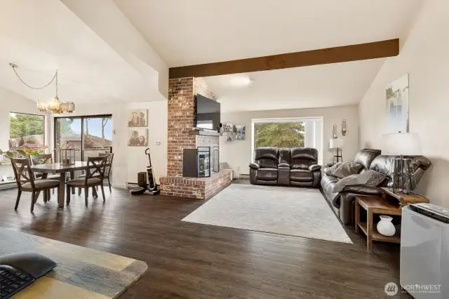 Large open space with a lovely living room with a fireplace and formal dining area.