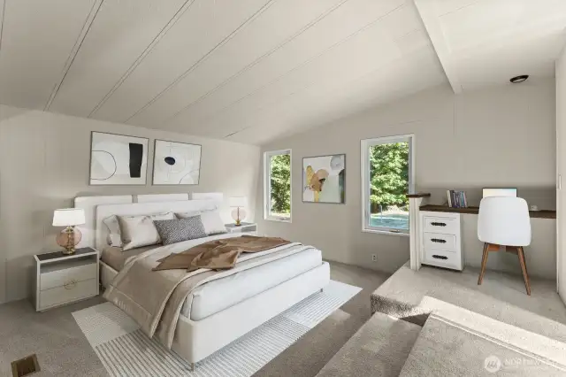 Primary w/ small desk & vaulted ceilings.