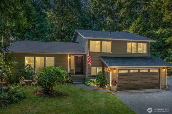 Nestled on a private lot framed by evergreens, this welcoming tri-level home offers warmth and character from the moment you arrive. A charming entry, accented by thoughtfully landscaped garden beds and a classic covered front porch, sets the stage for what awaits inside.