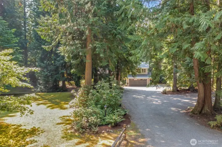 As you turn into the long driveway, the home comes into view through a canopy of mature trees. This serene setting provides both privacy and a natural retreat while still keeping you close to all the conveniences of the Sammamish Plateau.