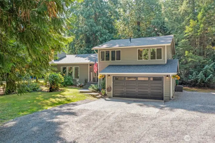 A closer look reveals a generous front yard, spacious driveway, and a two-car garage. There’s plenty of room for additional parking, making it easy to host gatherings or accommodate outdoor activities.