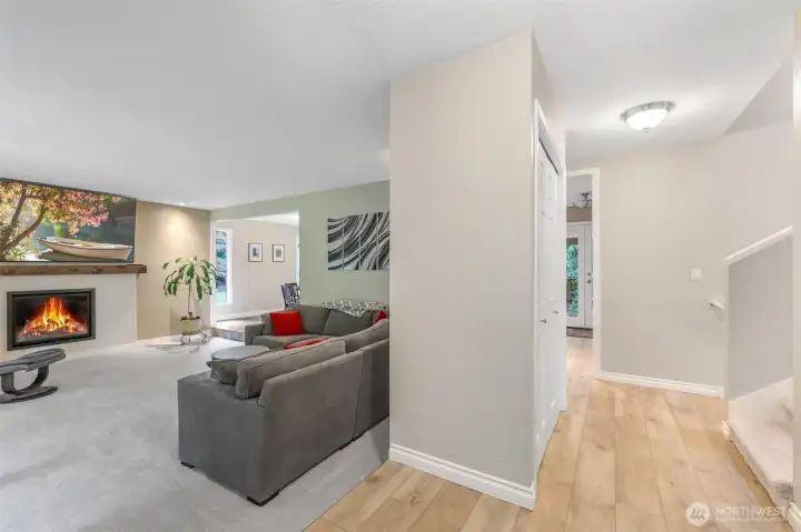 Step inside to find a bright and open living area. The foyer transitions smoothly into the main living spaces, highlighting wood-style flooring and a functional layout designed for everyday living.