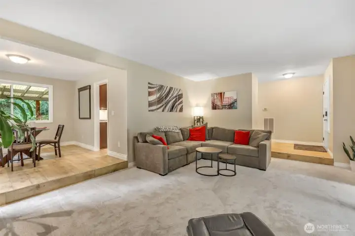 From this angle, you can appreciate the open connection between the living and dining spaces. Neutral tones, fresh flooring, and generous room dimensions offer flexibility for your personal style.