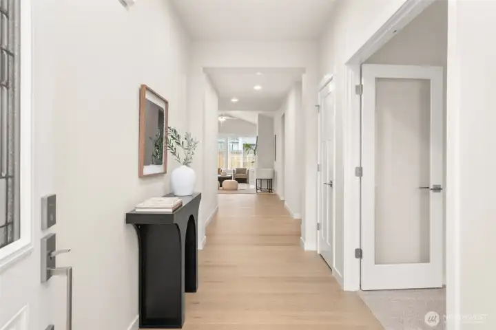 Staged Large Entryway-Entryway featuring hardwood floors extended through hallway.