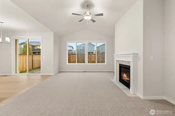 Vaulted ceilings and a cozy fireplace with tile surround & mantel. Wood wrap windows and screens are included.