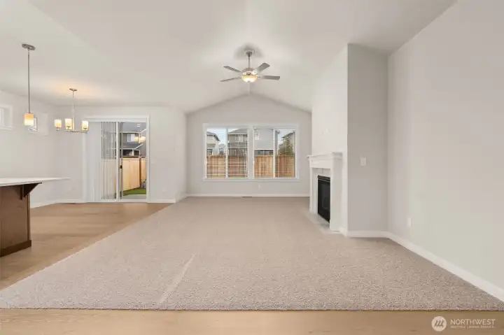 Vaulted ceilings and a cozy fireplace with tile surround & mantel. Wood wrap windows and screens are included.
