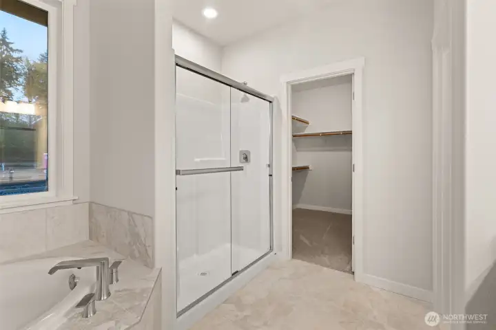 Primary bath comes standard with a separate walk-in shower with glass doors.