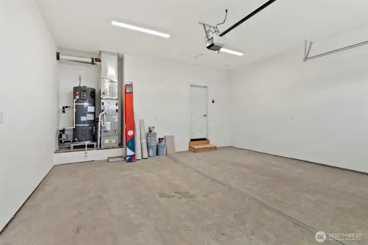 Double car garage is drywalled and includes garage door opener.
